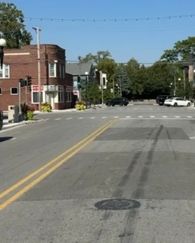 a view of city street with a houses