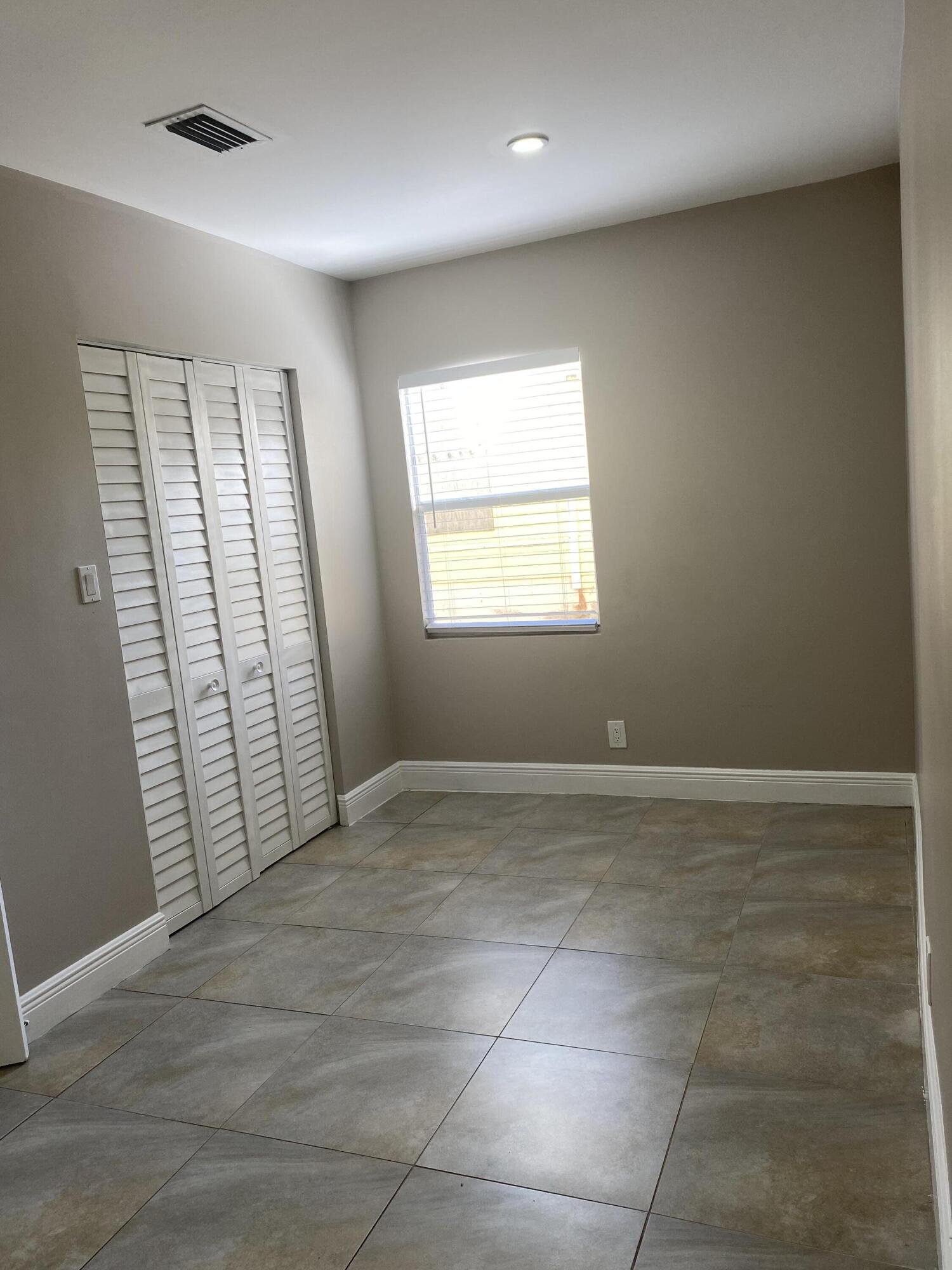 508 57th Street, Unit 3 West Palm Beach, FL 33407 - Photo 14 of 23 an empty room with windows