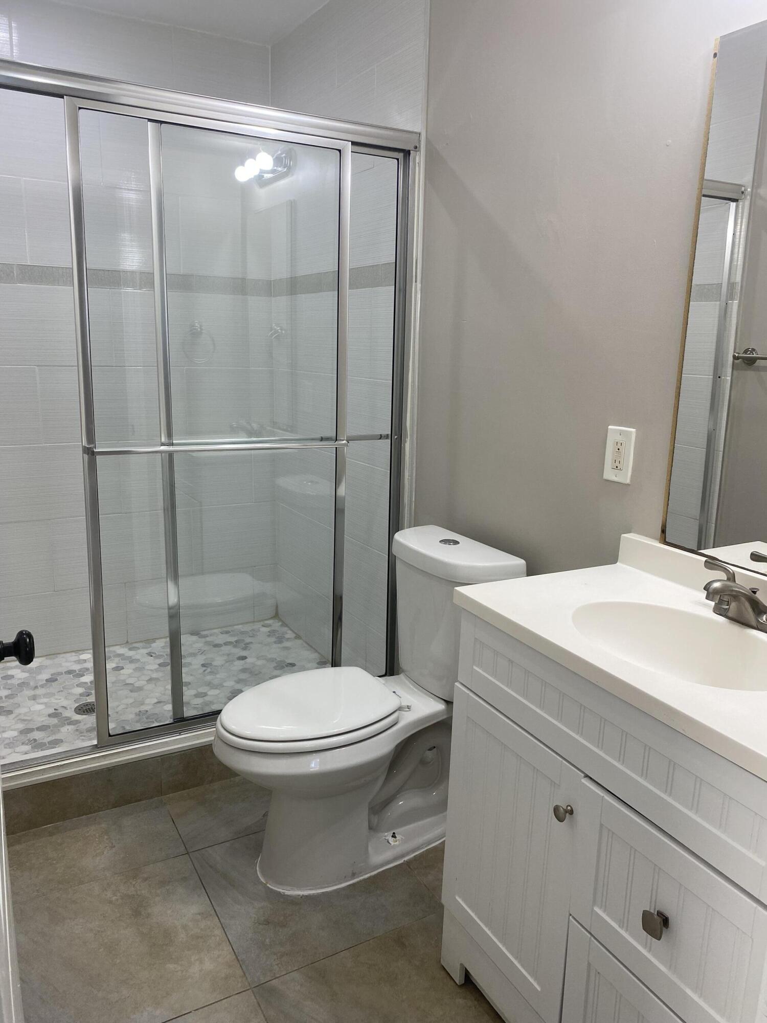508 57th Street, Unit 3 West Palm Beach, FL 33407 - Photo 15 of 23 a bathroom with a granite countertop toilet and a sink