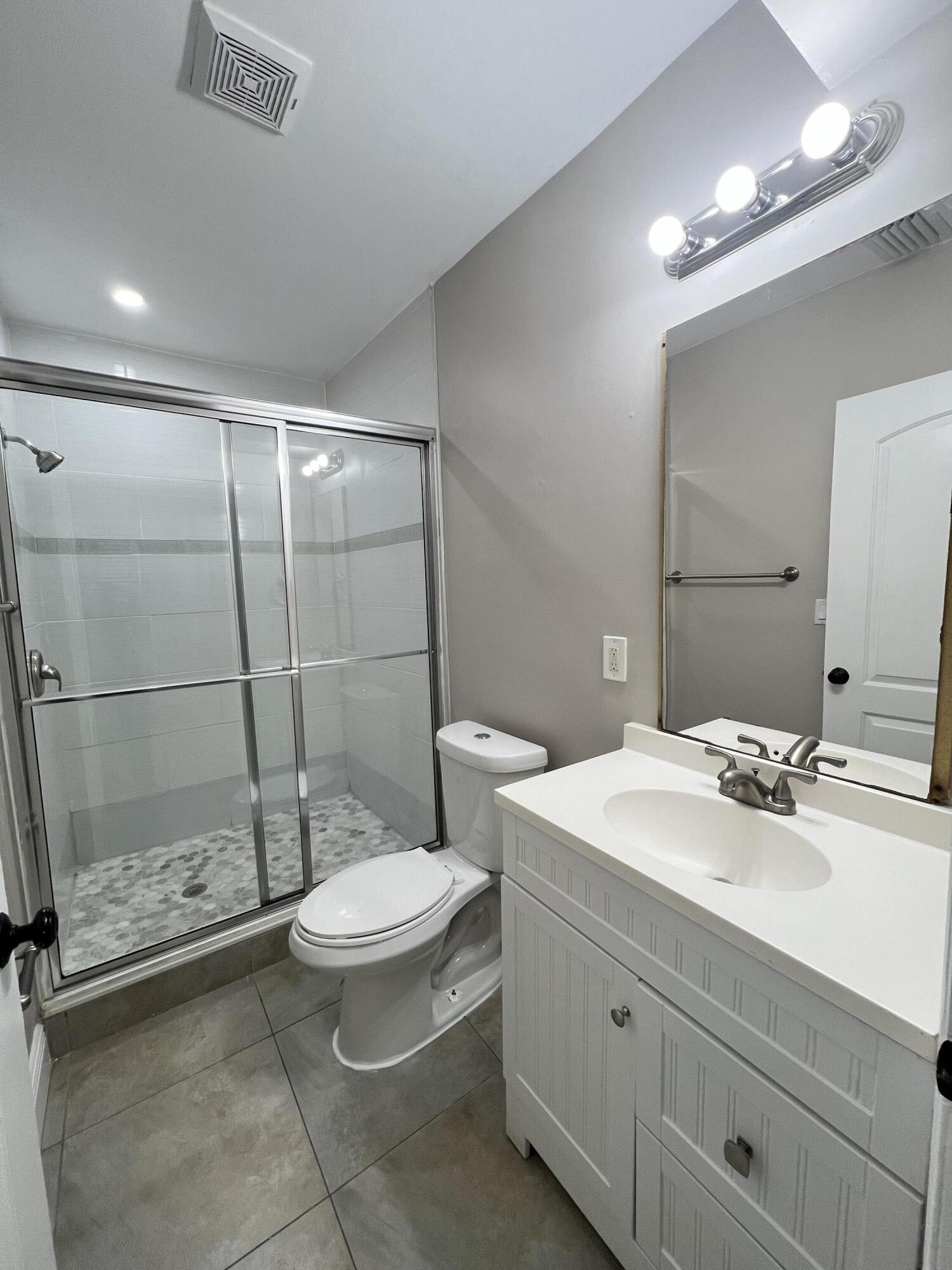 508 57th Street, Unit 3 West Palm Beach, FL 33407 - Photo 18 of 23 a bathroom with a sink toilet and shower