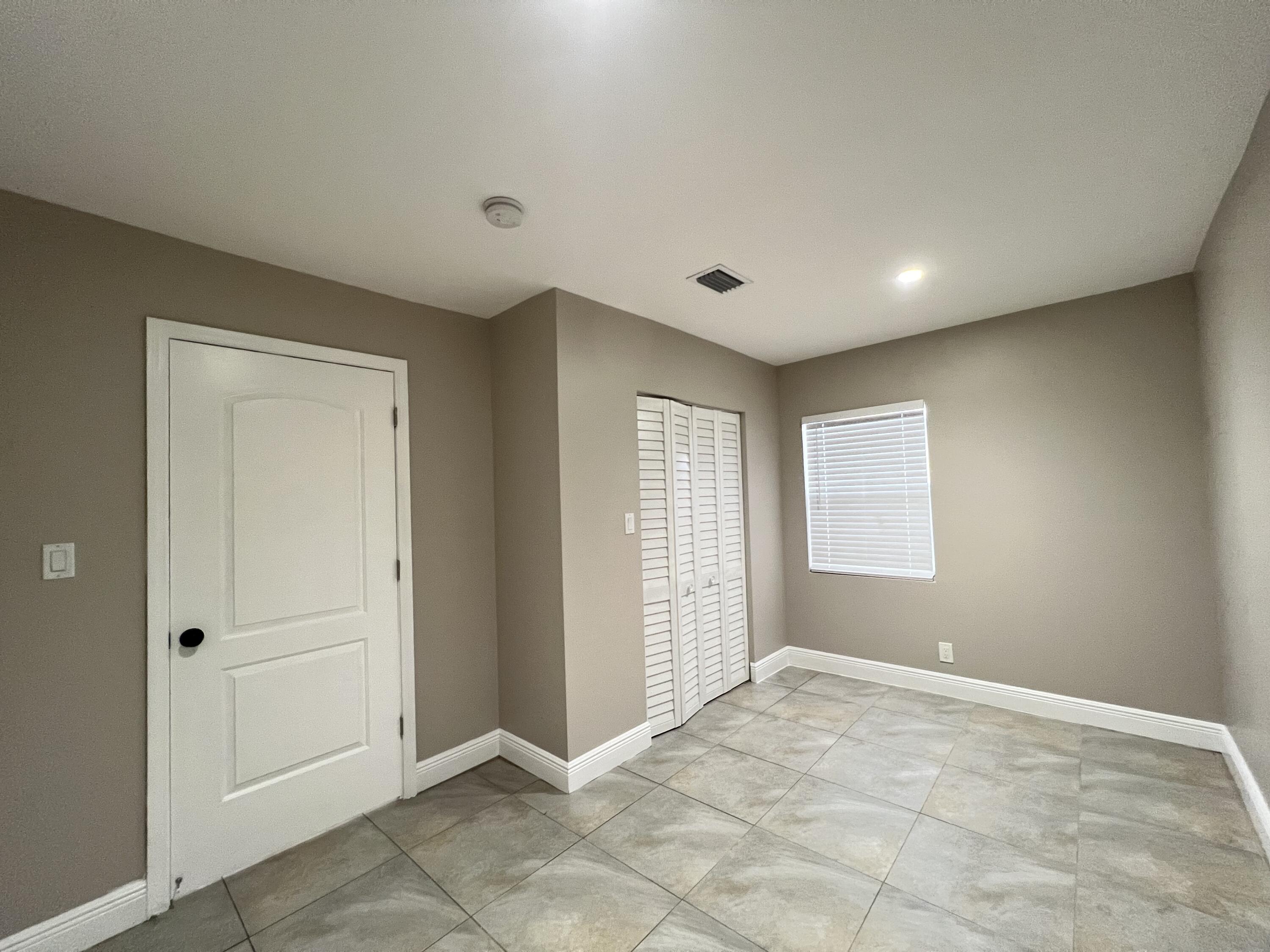 508 57th Street, Unit 3 West Palm Beach, FL 33407 - Photo 19 of 23 a view of an empty room and window