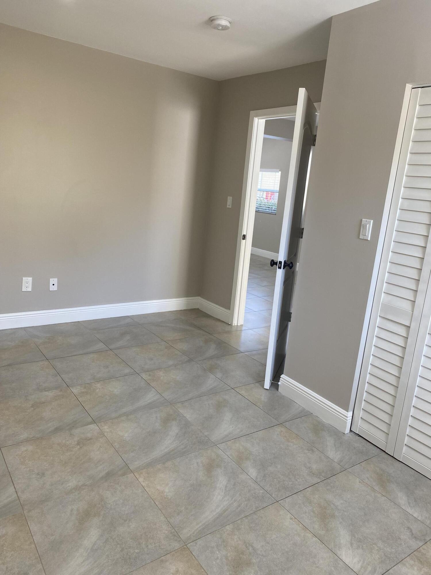 508 57th Street, Unit 3 West Palm Beach, FL 33407 - Photo 6 of 23 an empty room with windows