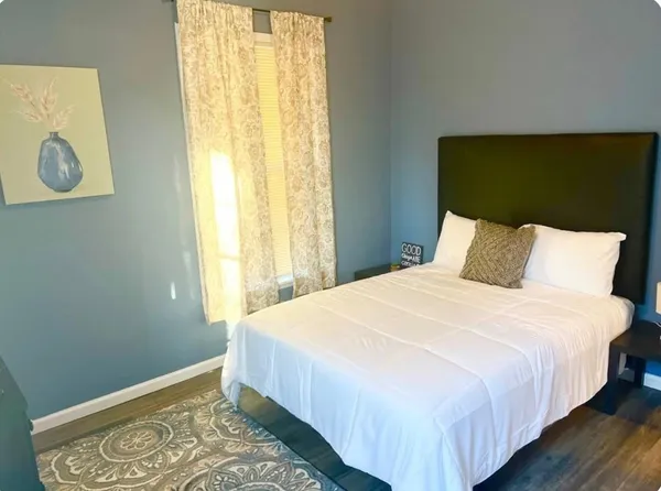 a bedroom with a bed and a window