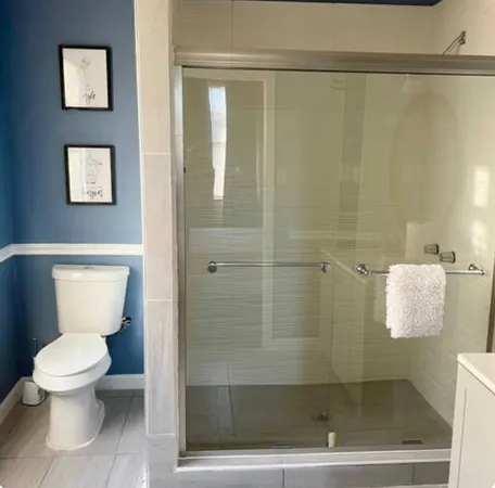 a bathroom with a toilet and a shower