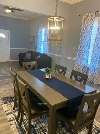 a view of a dining room with furniture and chandelier