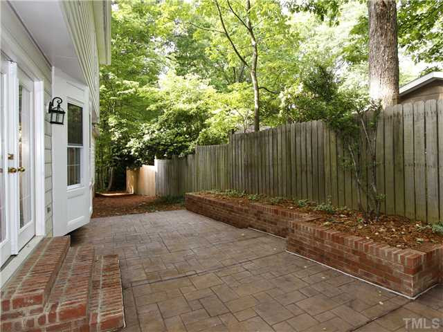 4301 Hickory Ridge Drive Raleigh, NC 27609 - Photo 22 of 25 This all new stamped concrete patio and brick planting beds add form and function to the back yard. Patio/Deck