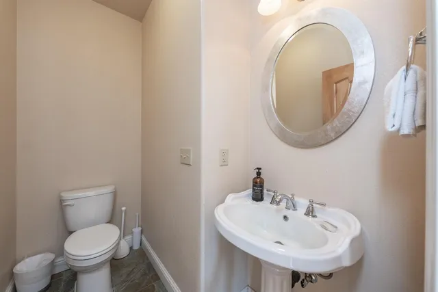 a living room with furniture a chandelier and a large window