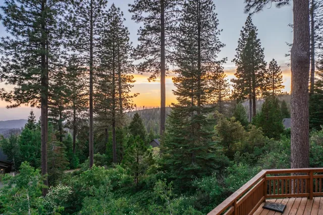a living room with furniture and large windows