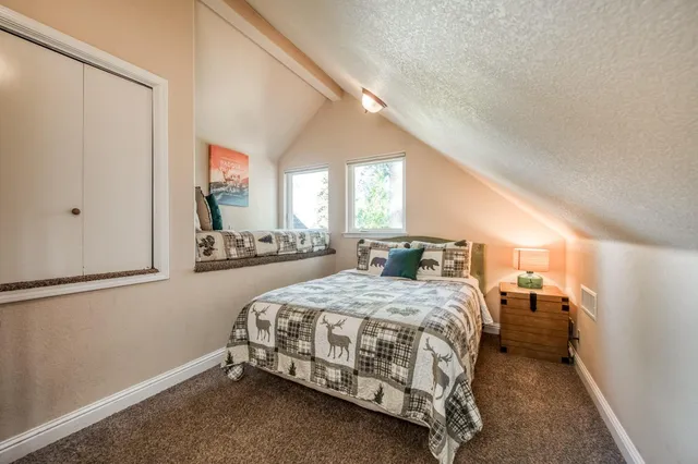 an aerial view of a house with a yard