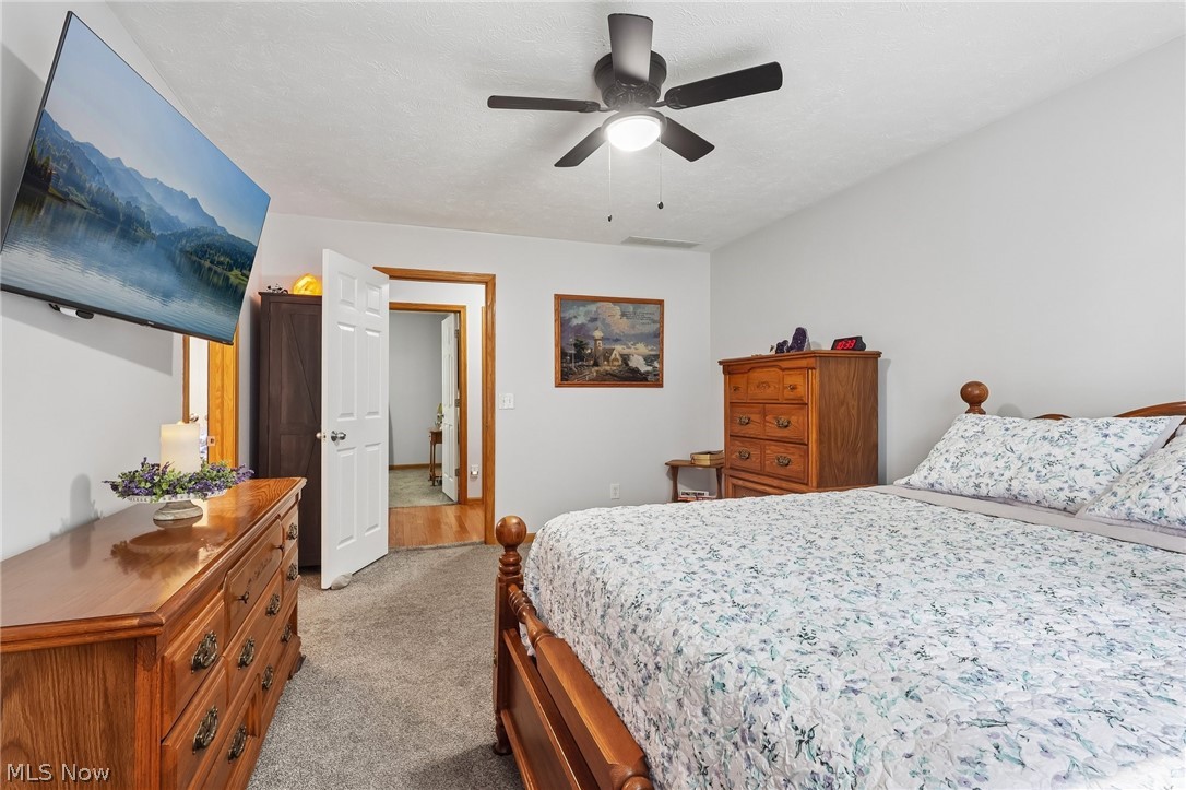 3213 Bates Road Madison, OH 44057 - Photo 20 of 45 Carpeted room featuring a ceiling fan with integrated lighting, white painted walls, and a white interior door