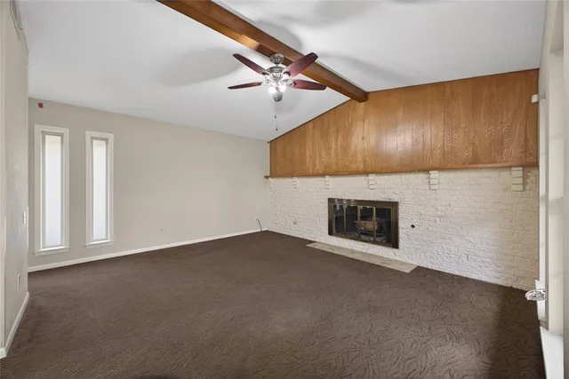 a view of an empty room with a fireplace