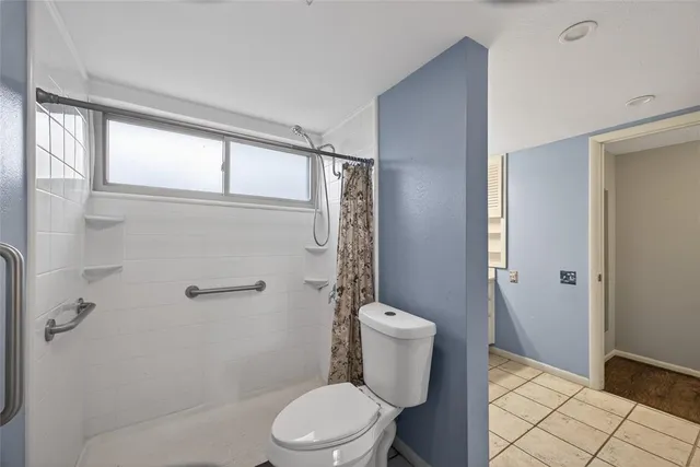 a white toilet sitting next to a bathroom sink