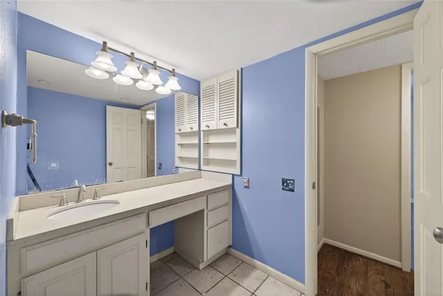 a bathroom with a double vanity sink and a mirror