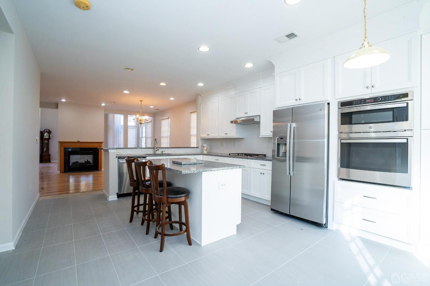 7 Stony Path Dayton, NJ 08810 - Photo 11 of 33 a kitchen with a refrigerator and a dining table