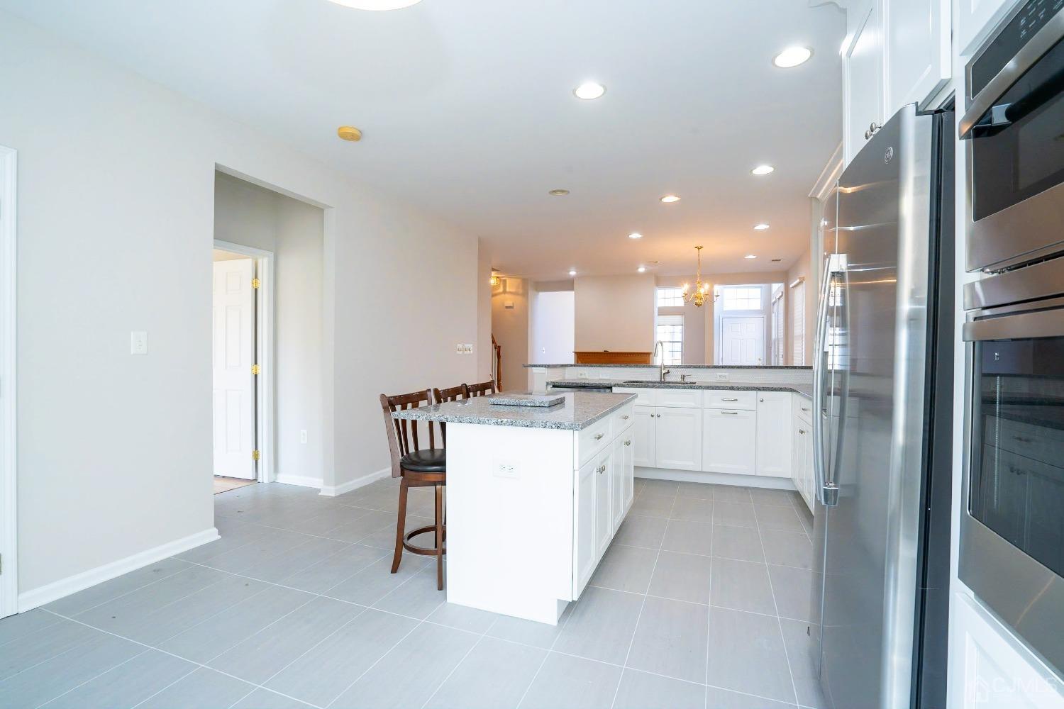 7 Stony Path Dayton, NJ 08810 - Photo 12 of 33 a kitchen with a sink cabinets and refrigerator