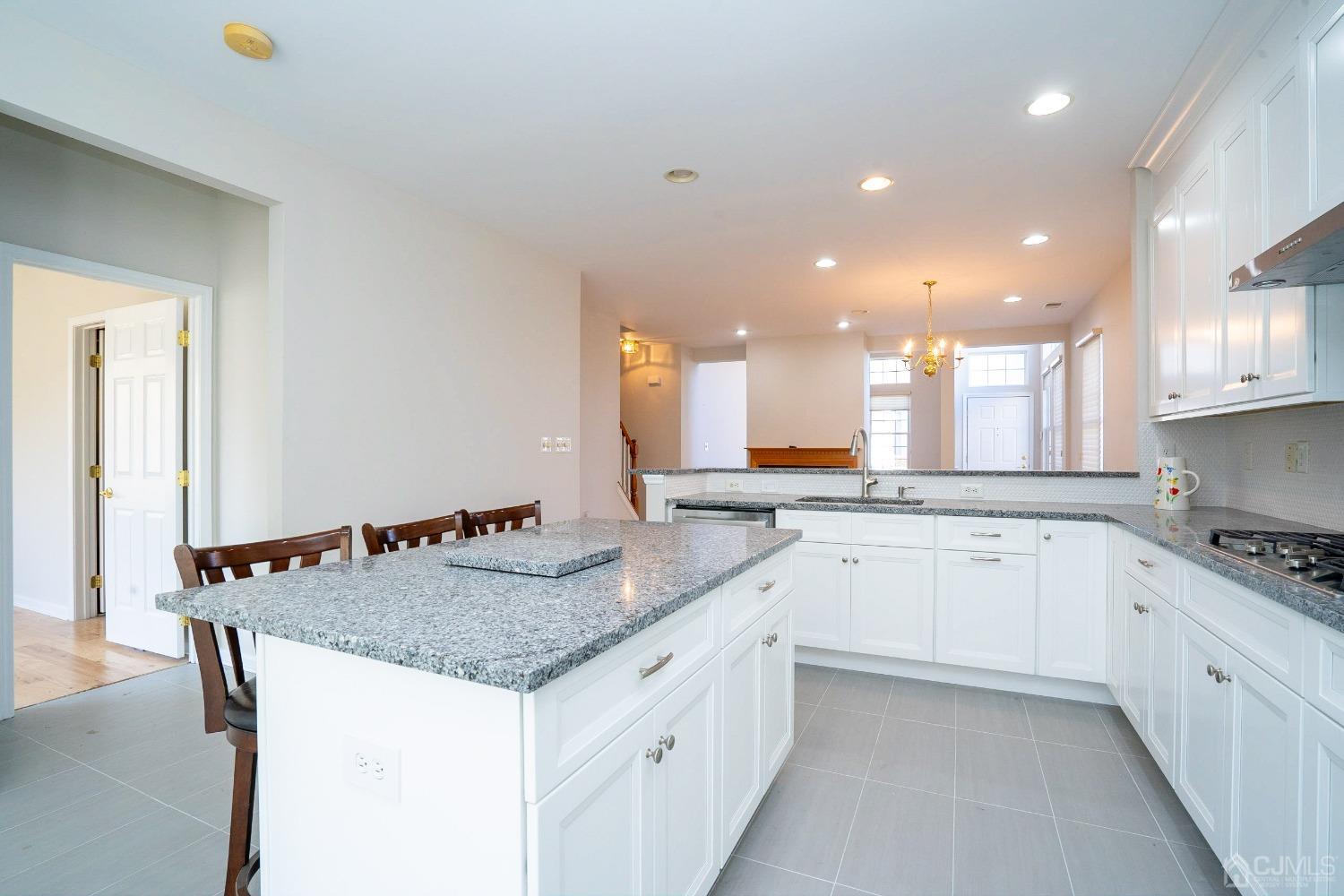 7 Stony Path Dayton, NJ 08810 - Photo 14 of 33 a large kitchen with granite countertop a sink and white cabinets