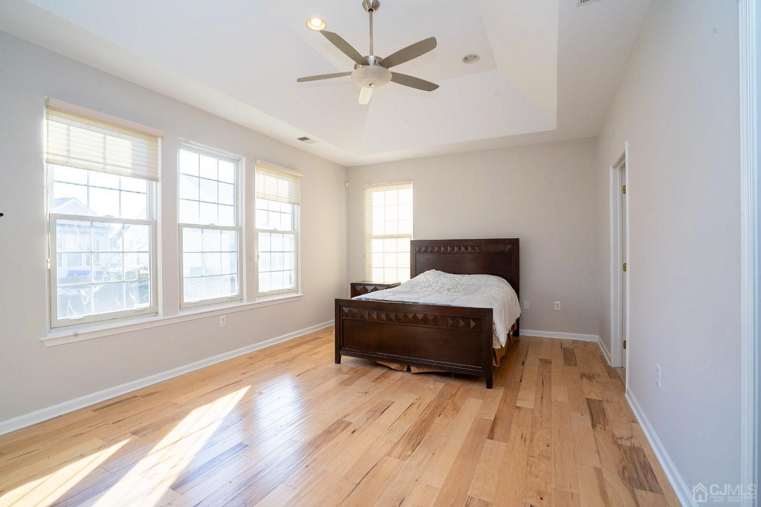 7 Stony Path Dayton, NJ 08810 - Photo 16 of 33 a spacious bedroom with a bed and a large window with wooden floor