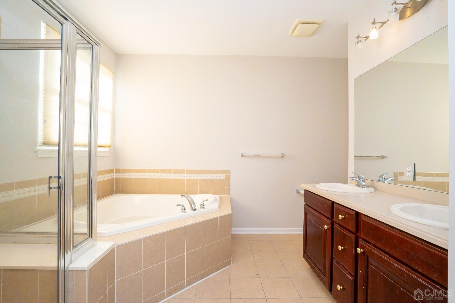7 Stony Path Dayton, NJ 08810 - Photo 18 of 33 a bathroom with a tub sink and mirror