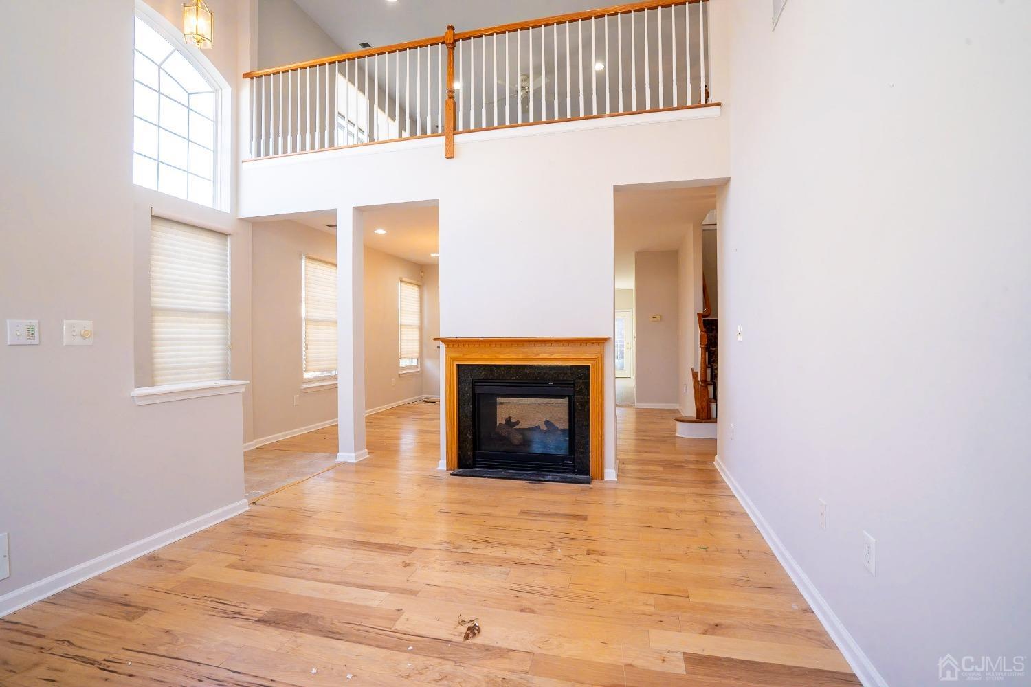 7 Stony Path Dayton, NJ 08810 - Photo 5 of 33 a view of a livingroom with wooden floor and a fireplace