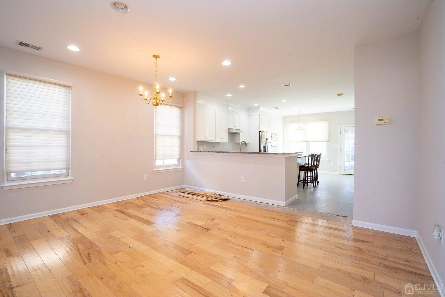 7 Stony Path Dayton, NJ 08810 - Photo 7 of 33 a view of a kitchen with kitchen island a sink wooden floor and a view of living room