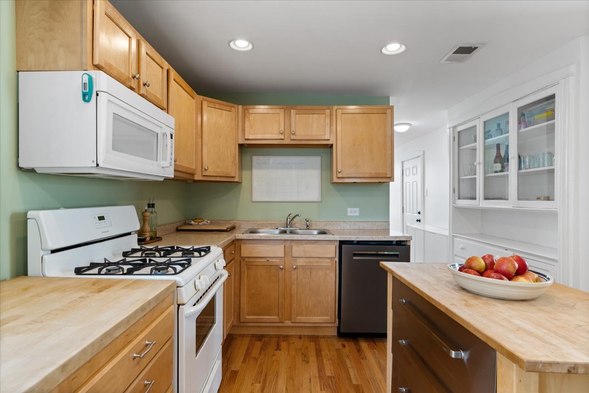 2735 North Ridgeway Avenue Chicago, IL 60647 - Photo 8 of 40 a kitchen with stainless steel appliances granite countertop a sink stove and refrigerator