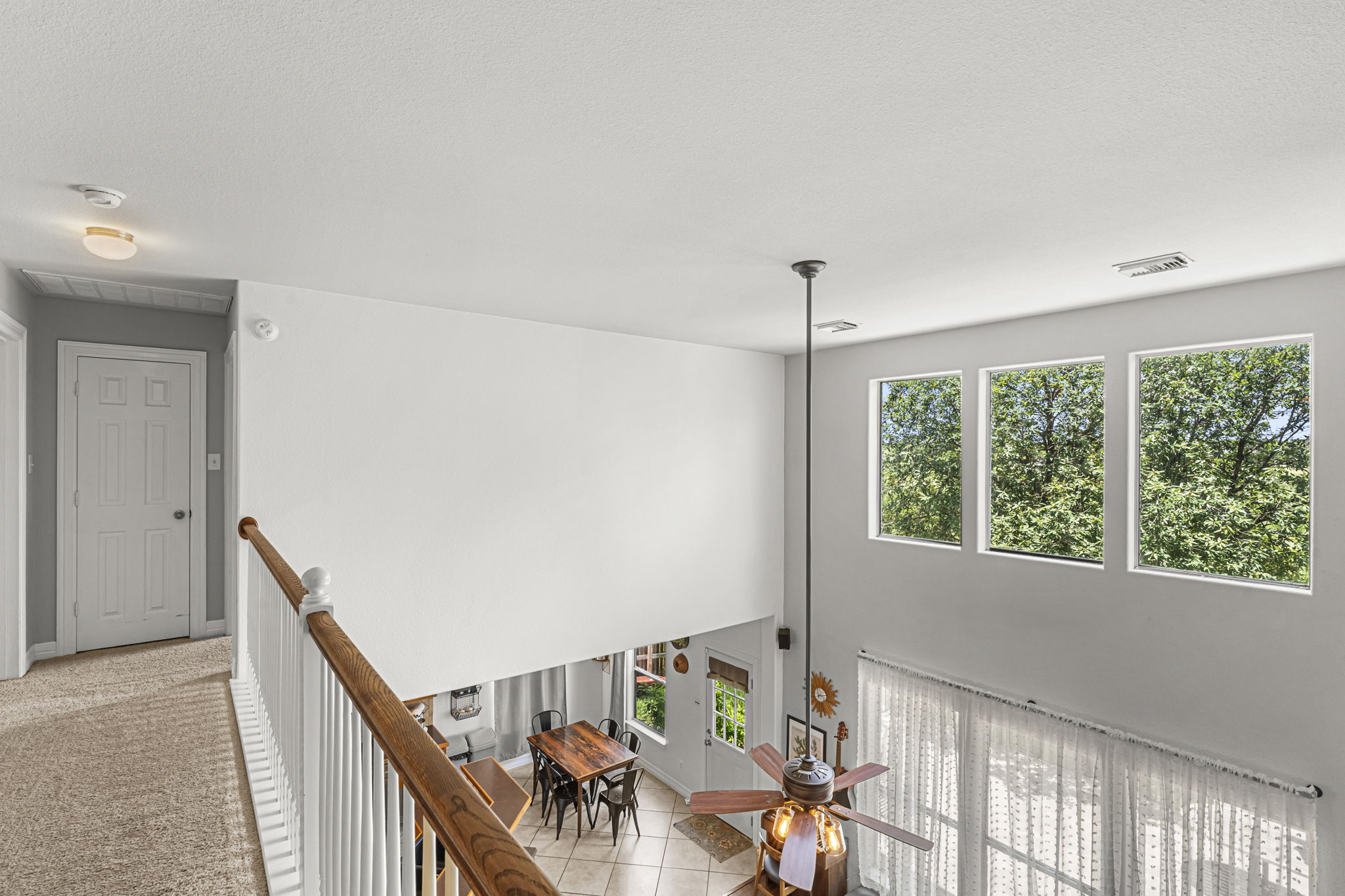 454 Fall Circle Kyle, TX 78640 - Photo 28 of 39 A spacious, airy interior offers tree-lined views through multiple tall windows.