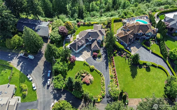 an aerial view of residential house with outdoor space and swimming pool