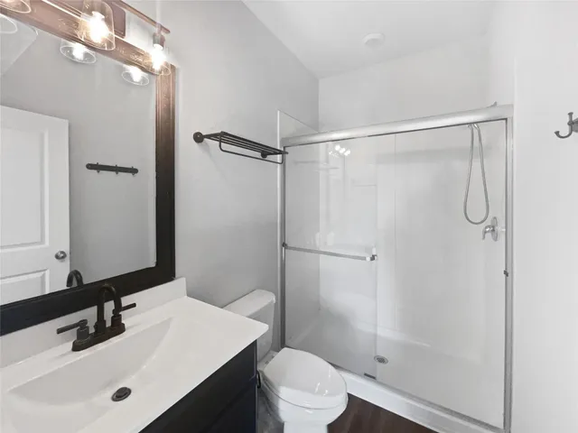 a bathroom with a sink toilet and shower
