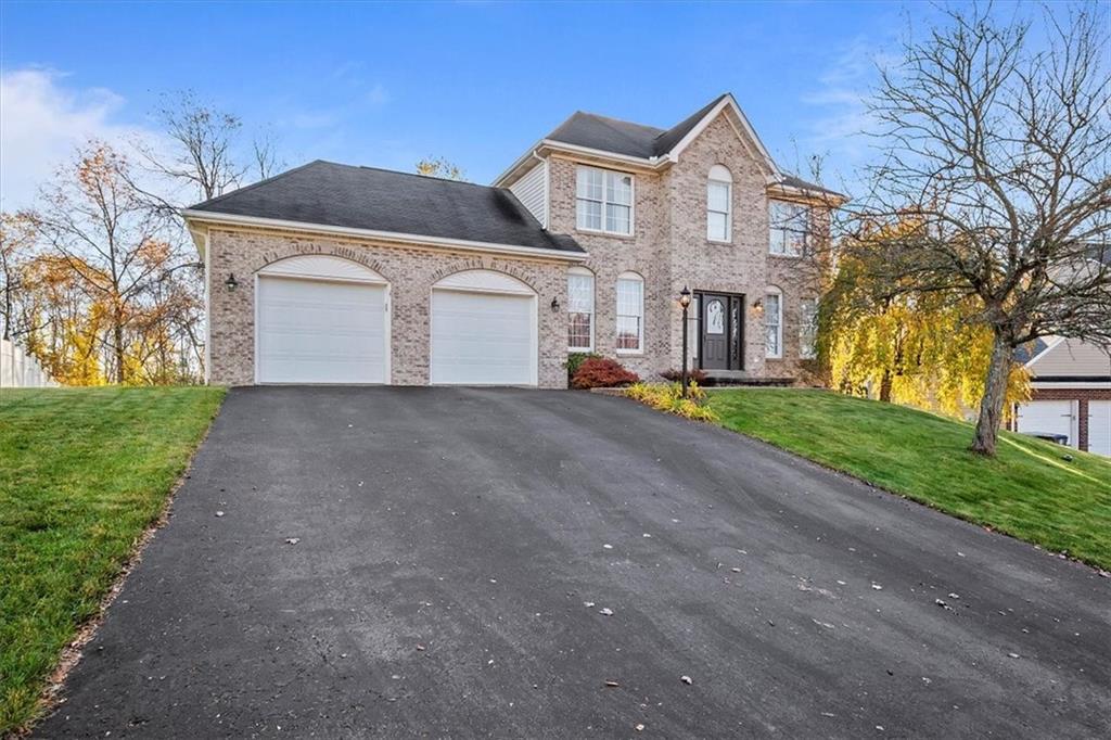 386 Pine Ridge Drive Venetia, PA 15367 - Photo 1 of 25 a front view of a house with a yard and garage