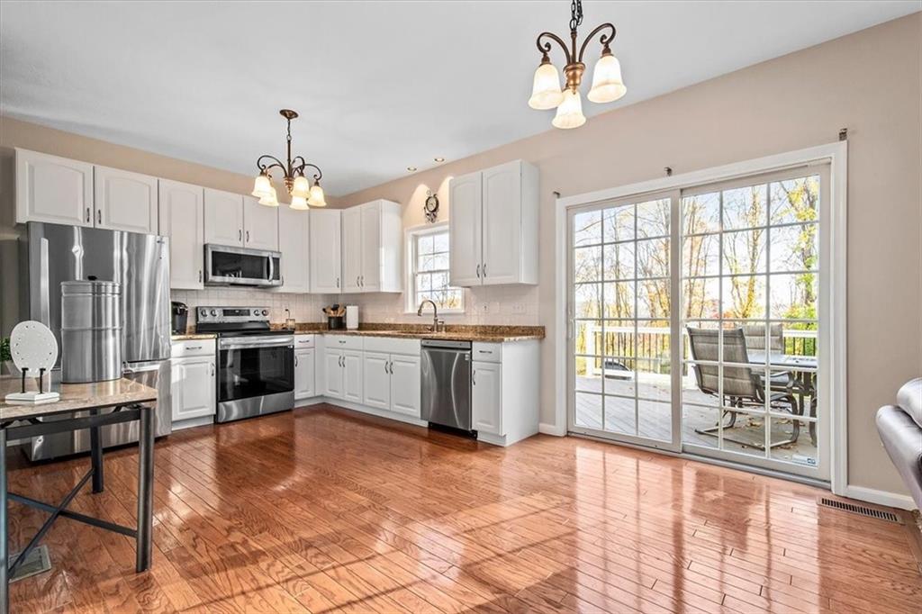 386 Pine Ridge Drive Venetia, PA 15367 - Photo 7 of 25 a kitchen with stainless steel appliances granite countertop a stove top oven a refrigerator a sink and a microwave