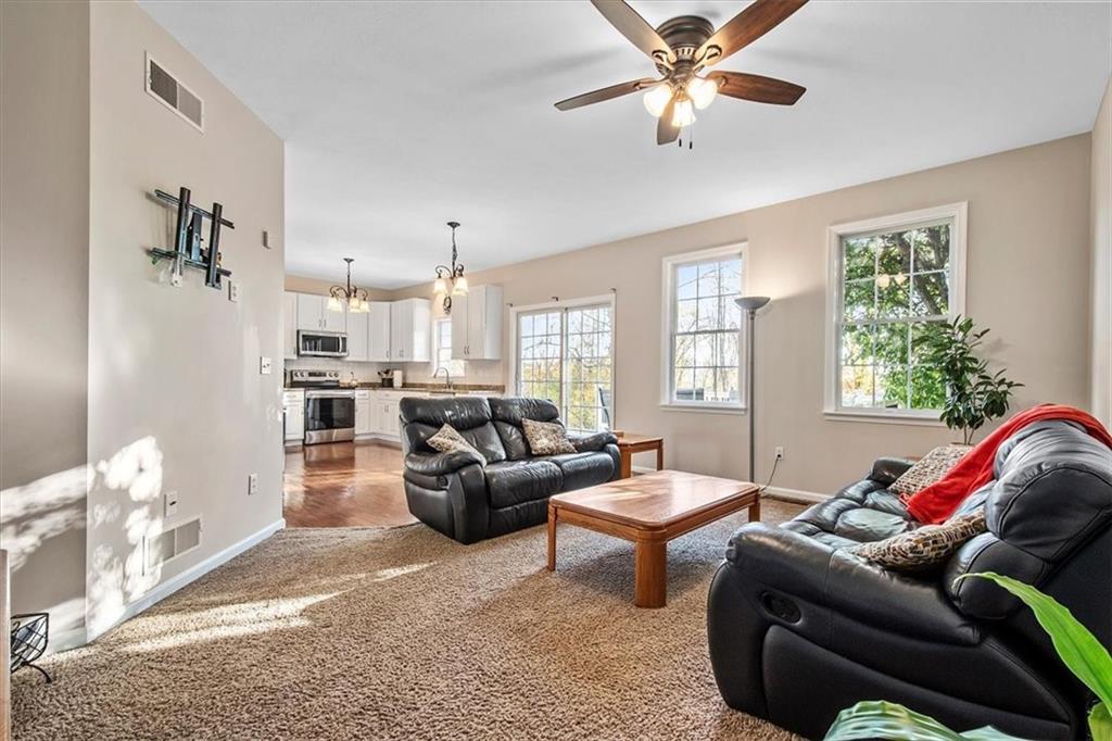 386 Pine Ridge Drive Venetia, PA 15367 - Photo 9 of 25 a living room with furniture ceiling fan and a window
