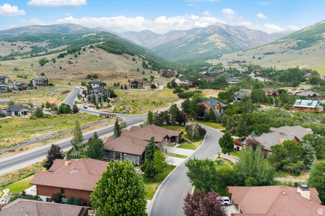 4892 Eagle Rdg Drive Eden, UT 84310 - Photo 38 of 39 Aerial perspective showcasing a residential community nestled among rolling hills and distant mountains