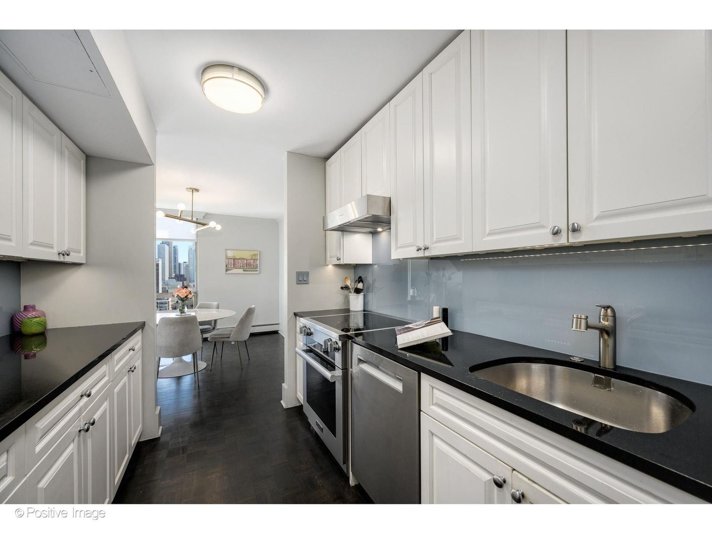 1310 North Ritchie Court, Unit 26C Chicago, IL 60610 - Photo 15 of 34 a kitchen with stainless steel appliances granite countertop a sink stove and cabinets
