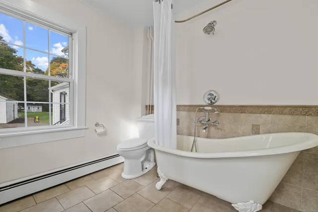 a white bath tub sitting next to a white toilet