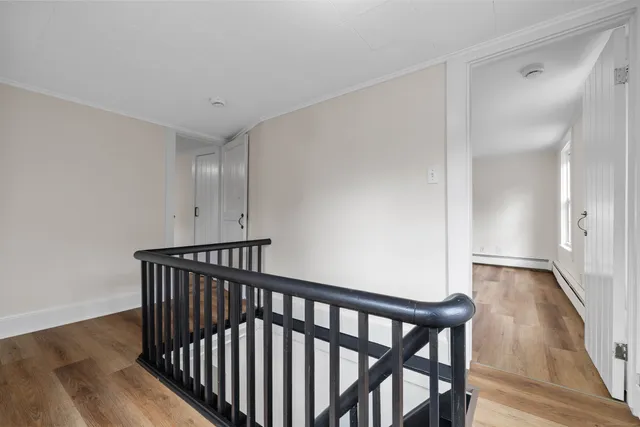 a view of hallway with wooden floor