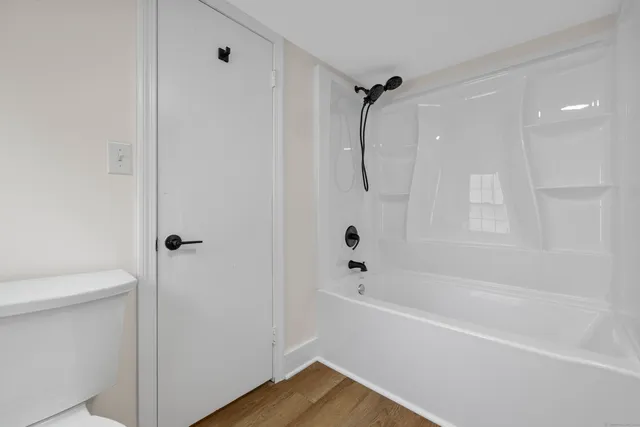 a bathroom with a bathtub a toilet and a shower