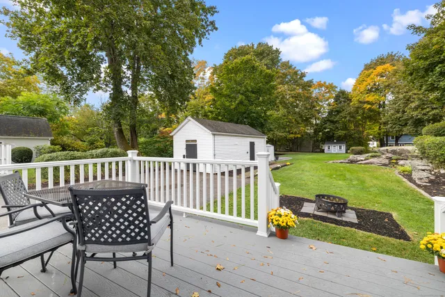a view of a white house with a yard