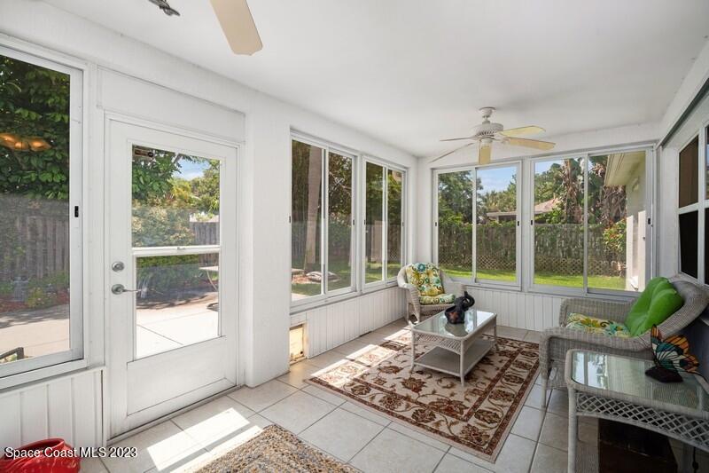 1102 Sunday Drive Rockledge, FL 32955 - Photo 12 of 16 a living room with couch and a floor to ceiling window