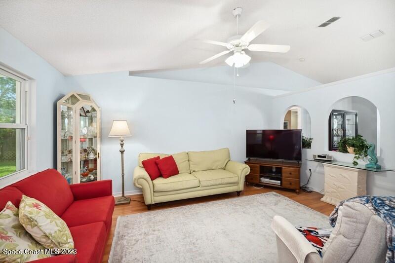 1102 Sunday Drive Rockledge, FL 32955 - Photo 5 of 16 a living room with furniture a flat screen tv and a fireplace