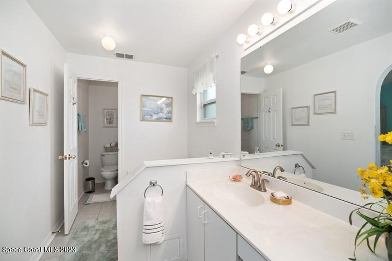 1102 Sunday Drive Rockledge, FL 32955 - Photo 7 of 16 a bathroom with a sink a toilet and shower