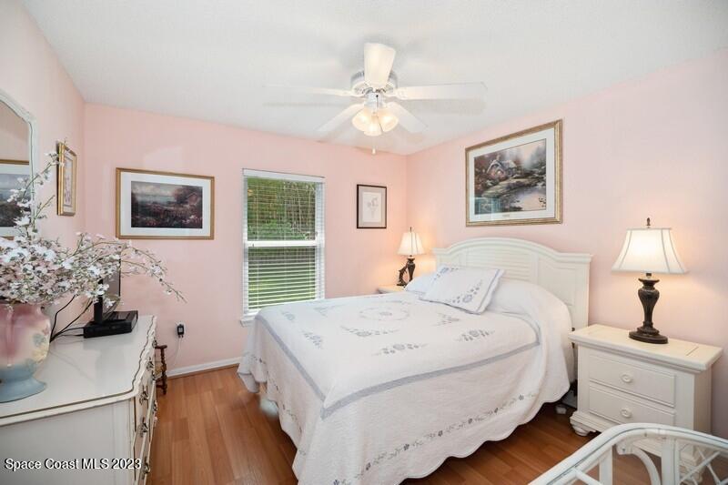 1102 Sunday Drive Rockledge, FL 32955 - Photo 8 of 16 a bedroom with a bed and a chandelier