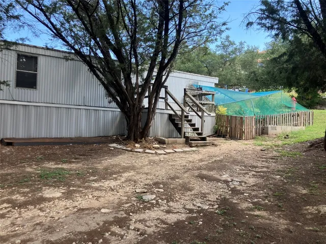 a view of a backyard with a tree