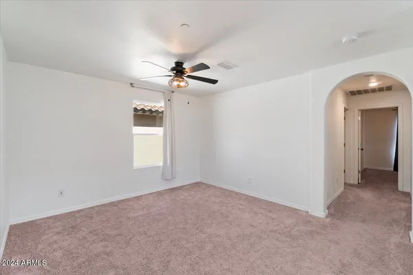 a view of a livingroom with a ceiling fan and window