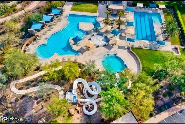a view of swimming pool with a yard and plants