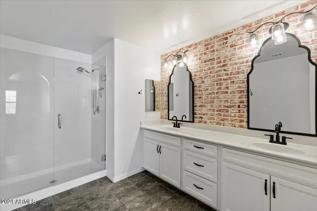 a bathroom with a double vanity sink and mirror