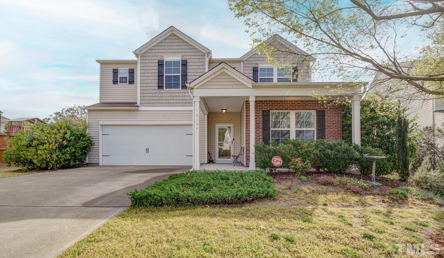 4104 Burnaby Street Raleigh, NC 27616 - Photo 1 of 59 a front view of a house with a yard and potted plants