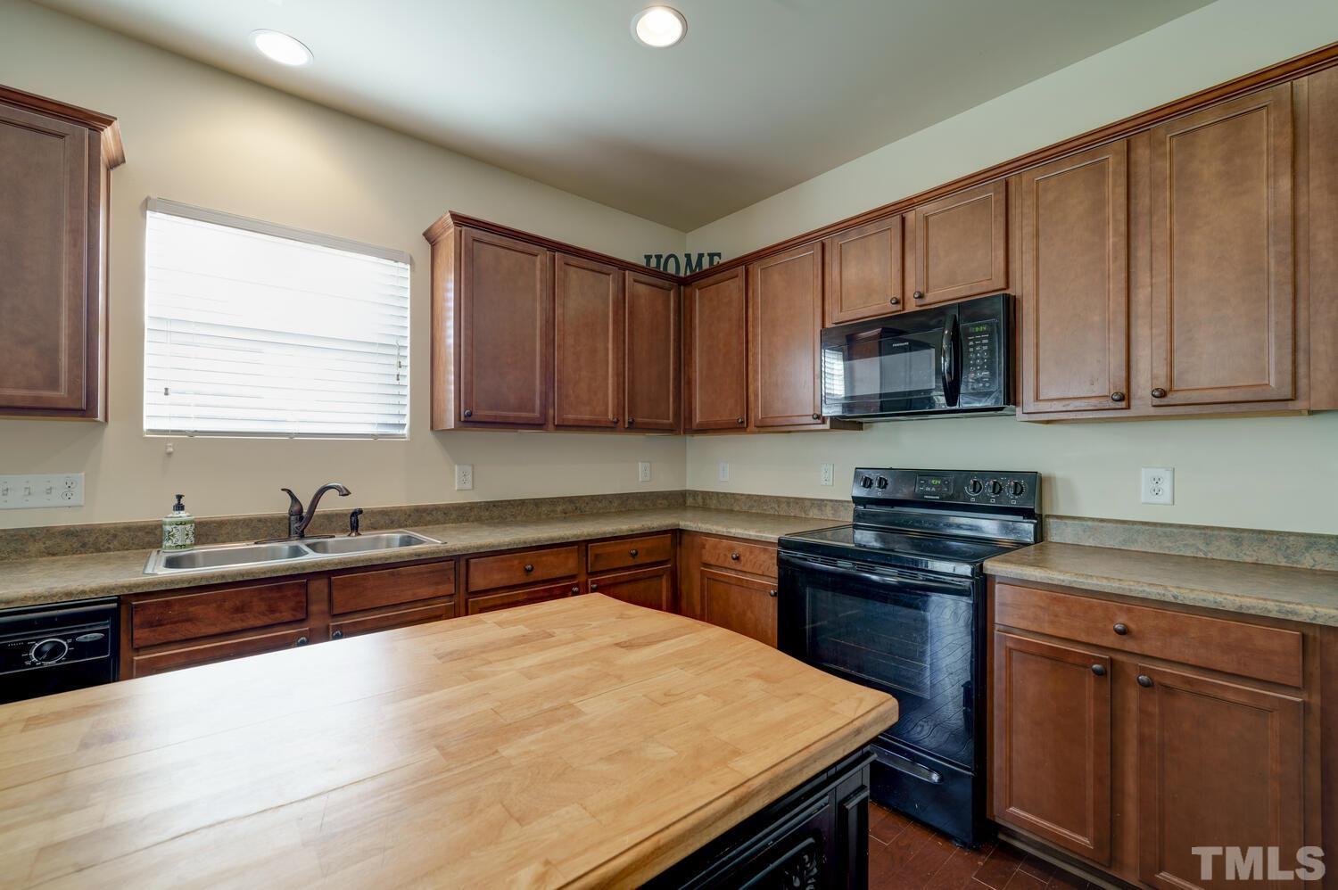 4104 Burnaby Street Raleigh, NC 27616 - Photo 13 of 59 a kitchen with a sink and cabinets
