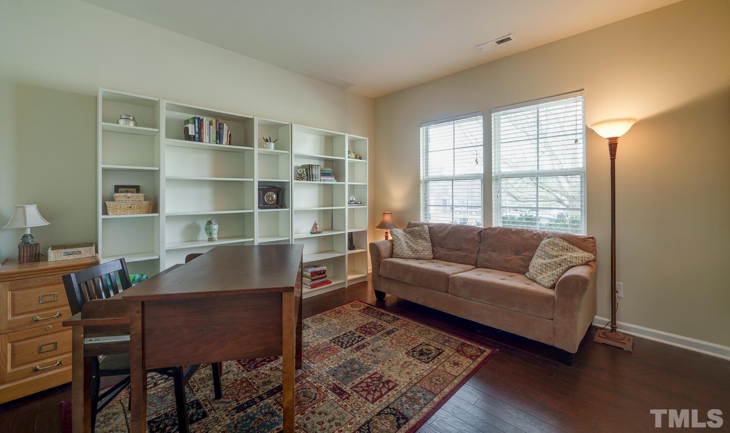 4104 Burnaby Street Raleigh, NC 27616 - Photo 15 of 59 a living room with furniture and a book shelf