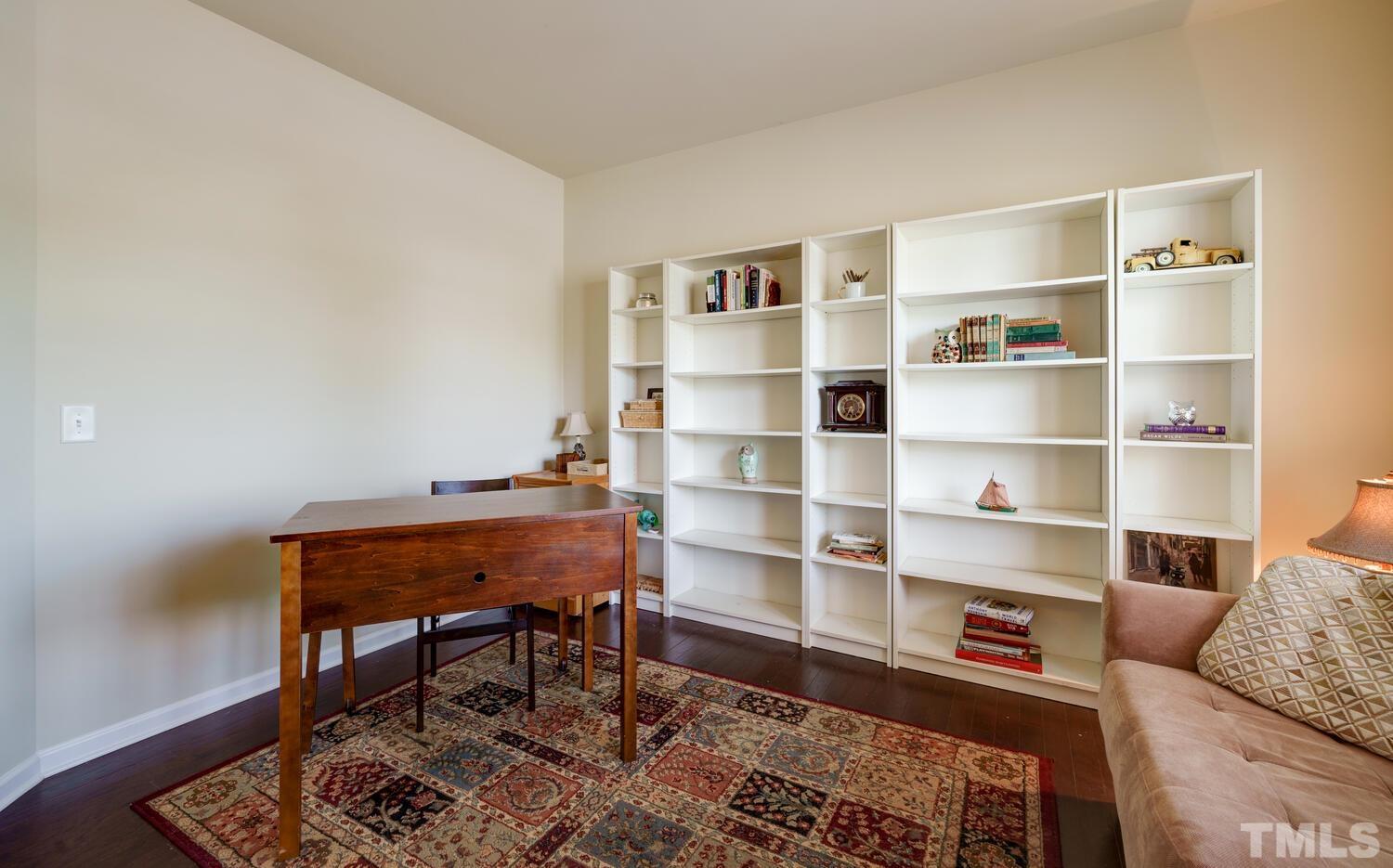 4104 Burnaby Street Raleigh, NC 27616 - Photo 16 of 59 a room with a furniture bookshelf and a window