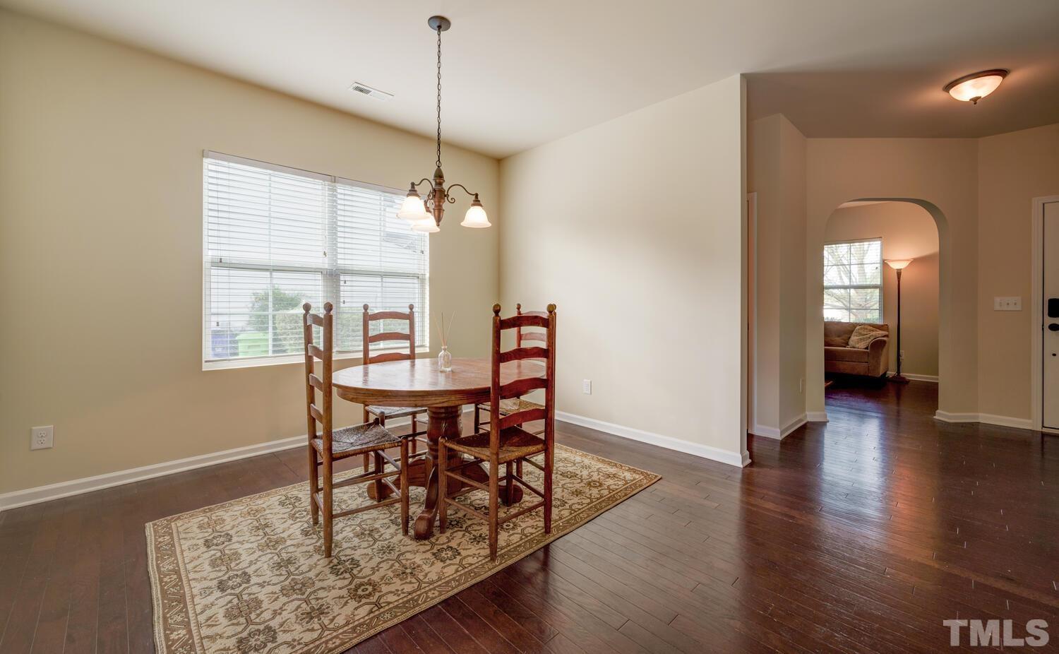4104 Burnaby Street Raleigh, NC 27616 - Photo 17 of 59 a view of a dining room with furniture window and wooden floor